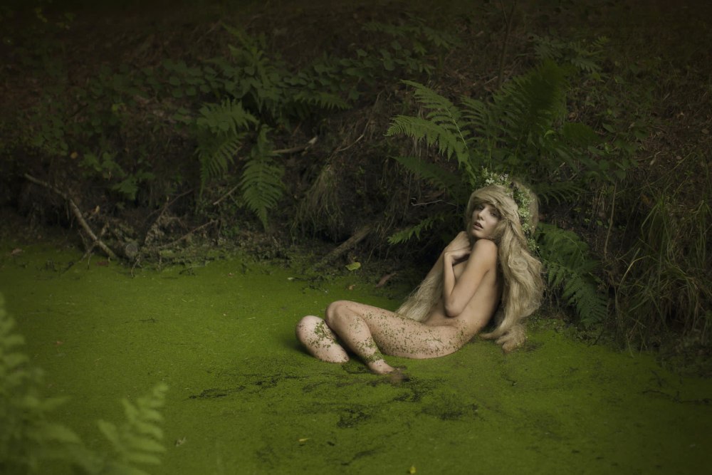 Girl swimming in a pond nude